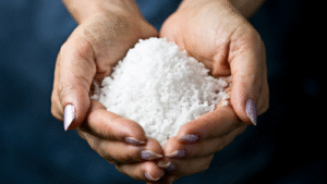 A person holding salt as a prized commodity in their hands