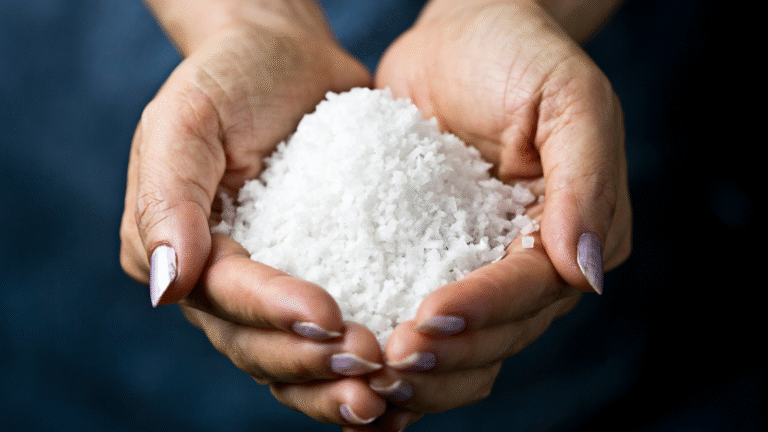 A person holding salt as a prized commodity in their hands