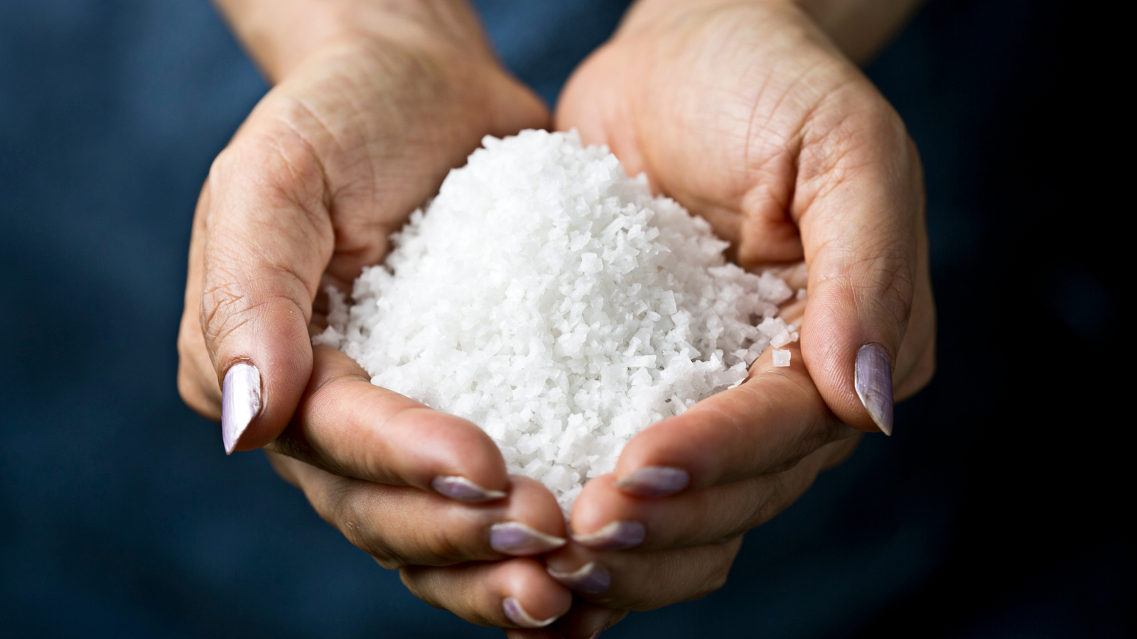 A person holding salt as a prized commodity in their hands